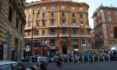 a large building with cars parked in front of it at A Casa di Giulia in Rome