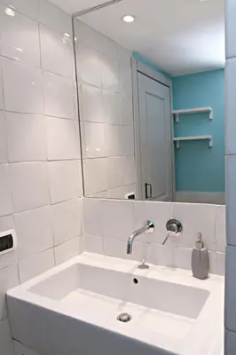 a white bathroom with a sink and a mirror at Sweet Rome Colosseo in Rome