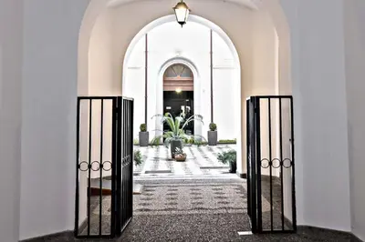 an entrance to a building with an open gate at Sweet Rome Colosseo in Rome