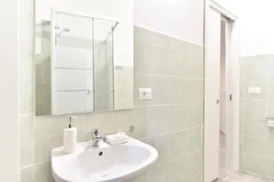 a bathroom with a sink and a mirror at GuestHouse o Affittacamere Magenta Baylon Suite in Rome