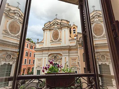 a window view of a building with a church at GuestHouse o Affittacamere Magenta Baylon Suite in Rome