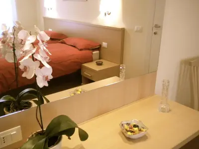 a bedroom with a bed and a mirror at Alba Romana in Rome