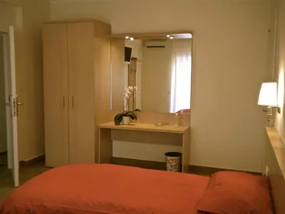 a bedroom with a bed and a large mirror at Alba Romana in Rome
