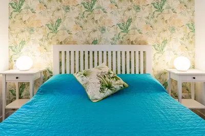 a bedroom with a blue bed with two night stands at Good Vibes Rome comfort and quality in Rome