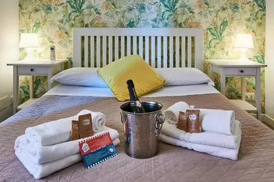 a bedroom with a bed with towels on it at Good Vibes Rome comfort and quality in Rome