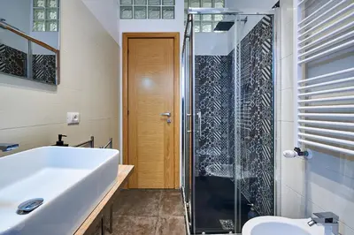 a bathroom with a sink and a glass shower at Good Vibes Rome comfort and quality in Rome