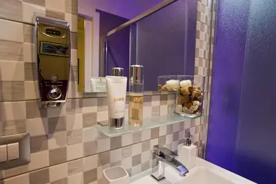 a bathroom with a sink and a mirror at Borghese Executive Suite in Rome