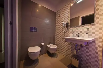 a bathroom with a toilet and a sink at Borghese Executive Suite in Rome