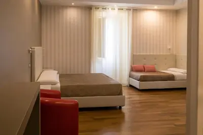 a small room with two beds and a couch at Borghese Executive Suite in Rome