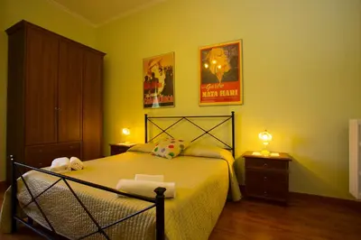 a bedroom with a bed and two night stands at Laterano Inn in Rome