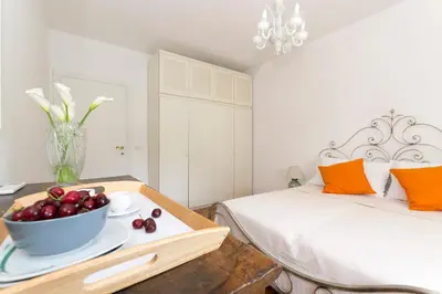 a bedroom with a bed and a bowl of fruit on a table at Ad Astra Suite in Rome