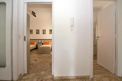 a hallway with white walls and a room with a bed at Ad Astra Suite in Rome