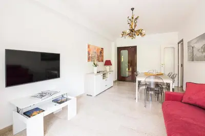 a living room with a red couch and a table at Ad Astra Suite in Rome