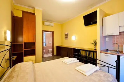 a bedroom with a bed and a bathroom with a sink at B&B La Porta in Rome