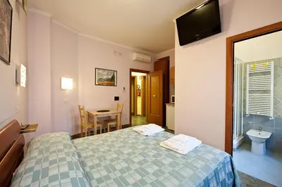 a hotel room with a bed and a bathroom at B&B La Porta in Rome