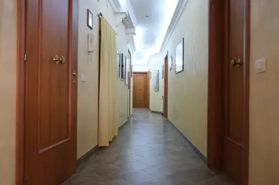 a hallway with many doors and a tile floor at B&B La Porta in Rome