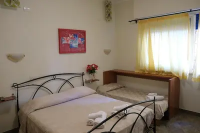 a bedroom with two beds and a window at B&B La Porta in Rome