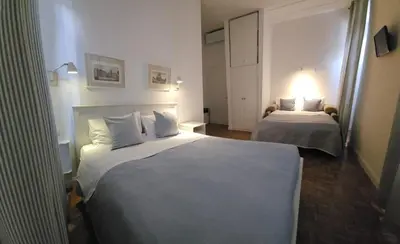 a hotel room with two beds and a lamp at Residenza I Rioni Guesthouse in Rome