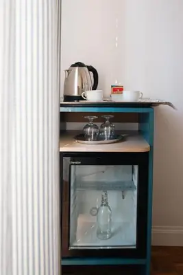 a small cabinet with a bottle in it in a kitchen at Residenza I Rioni Guesthouse in Rome