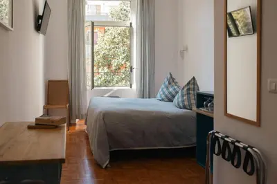 a bedroom with a bed and a window at Residenza I Rioni Guesthouse in Rome