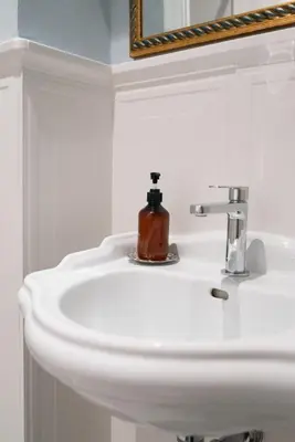 a white bathroom sink with a soap dispenser on it at Residenza I Rioni Guesthouse in Rome