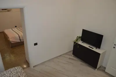 a living room with a flat screen tv on a cabinet at Apartment Silvestri in Rome