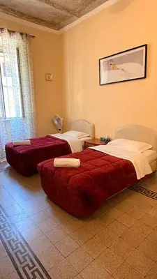 a hotel room with two beds with towels on a bed at Soggiorno Emanuela in Rome