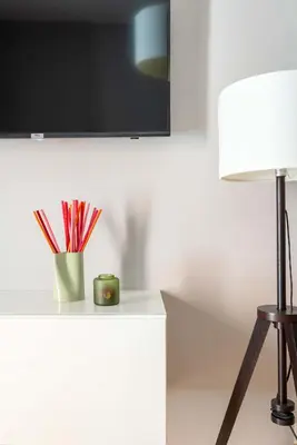 a table with a cup of pencils and a lamp at ELICAL Luxury Apartments in Rome