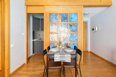a dining room with a table and chairs and a window at ELICAL Luxury Apartments in Rome