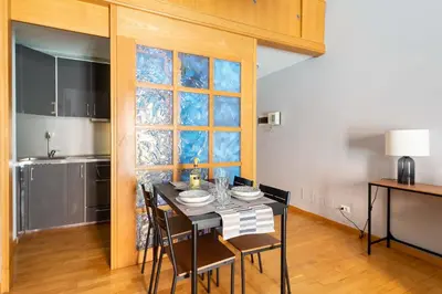 a dining room with a table and chairs and a window at ELICAL Luxury Apartments in Rome