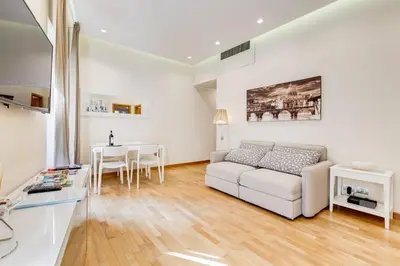 a living room with a white couch and a table at ELICAL Luxury Apartments in Rome