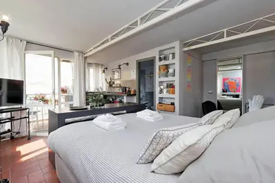 a bedroom with a large white bed with two pillows at Scala Luxury Terrace studio in Rome