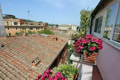 an apartment balcony with flowers on a building at Scala Luxury Terrace studio in Rome