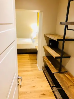 a small room with a bunk bed and wooden floors at Giselda Home in Rome