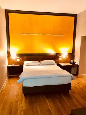 a bedroom with a bed with a large painting on the wall at Giselda Home in Rome
