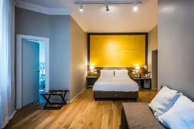 a hotel room with a bed and a couch at Giselda Home in Rome