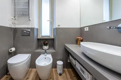 a bathroom with a white toilet and a sink at St. Peter's Refuge 2 in Rome