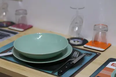 a stack of plates and a bowl on a table at Mila Guest House in Rome