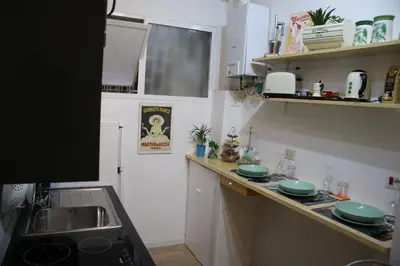 a kitchen with a sink and a counter top at Mila Guest House in Rome