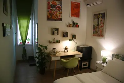 a room with a desk and a bed and a room with a bed at Mila Guest House in Rome