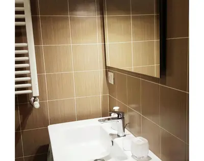 a bathroom with a white sink and a mirror at B&B Emozioni Romane in Rome