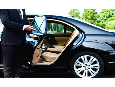a man in a suit getting into a car at B&B Emozioni Romane in Rome