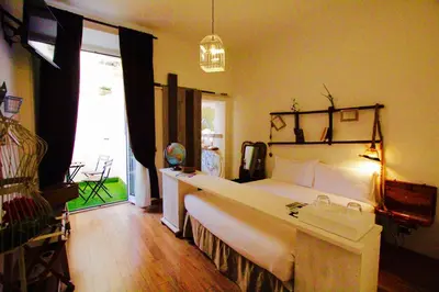 a bedroom with a large bed and a large window at Jacuzzi Rooms in Rome