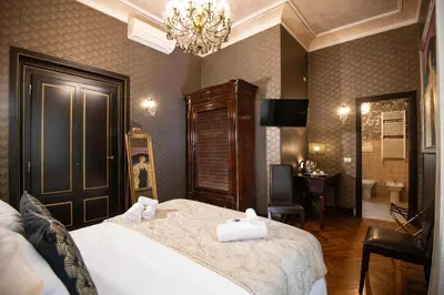 a bedroom with a bed with two towels on it at Contessa Arrivabene Antica Dimora in Rome