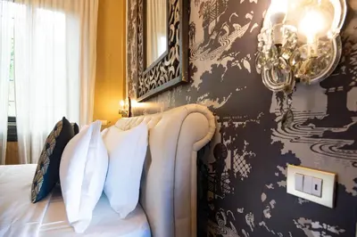 a bedroom with a bed with a black and white wall at Contessa Arrivabene Antica Dimora in Rome