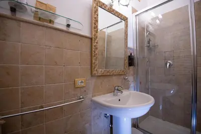 a bathroom with a sink and a shower and a mirror at Contessa Arrivabene Antica Dimora in Rome