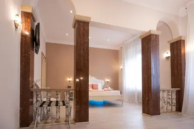 a room with columns with a bed in the background at Contessa Arrivabene Antica Dimora in Rome