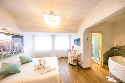 a bedroom with a large bed with a bow on it at Suites Roma Tiburtina Economy in Rome
