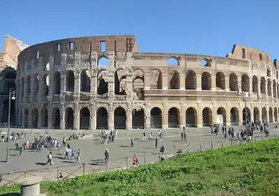 a group of people walking around the coliseum at LA PERLA RARA Vatican Sweet Home in Rome