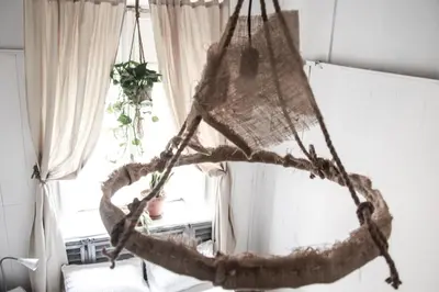 a hanging hammock in a room with a window at Coliving Trastevere in Rome